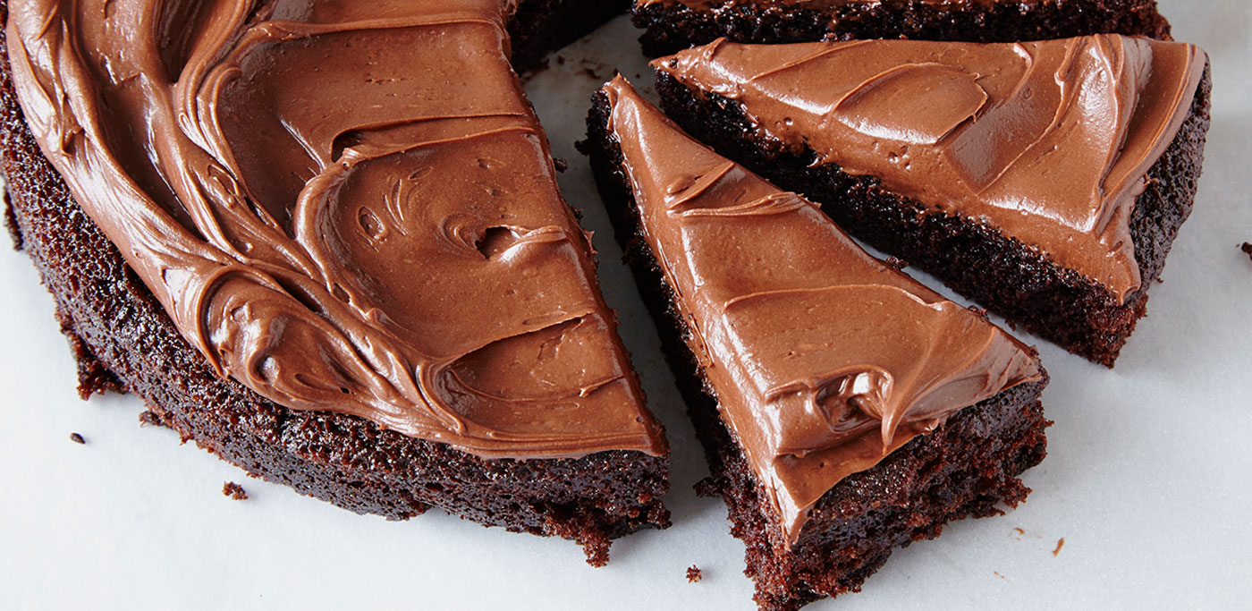 Sliced chocolate cake with chocolate frosting