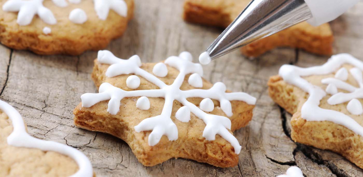 Royal Icing being piped onto a sugar cookie
